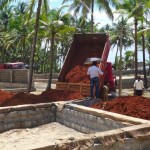 Site manager Pradeep supervising unloading the red sand