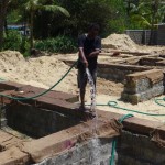 Neighbour helps to keep the concrete wet