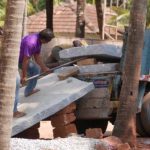 The granite slabs being unloaded manually