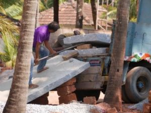 The granite slabs being unloaded manually