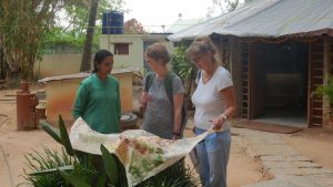 Padmini, Hege and May-Kristin look over some samples of block printing